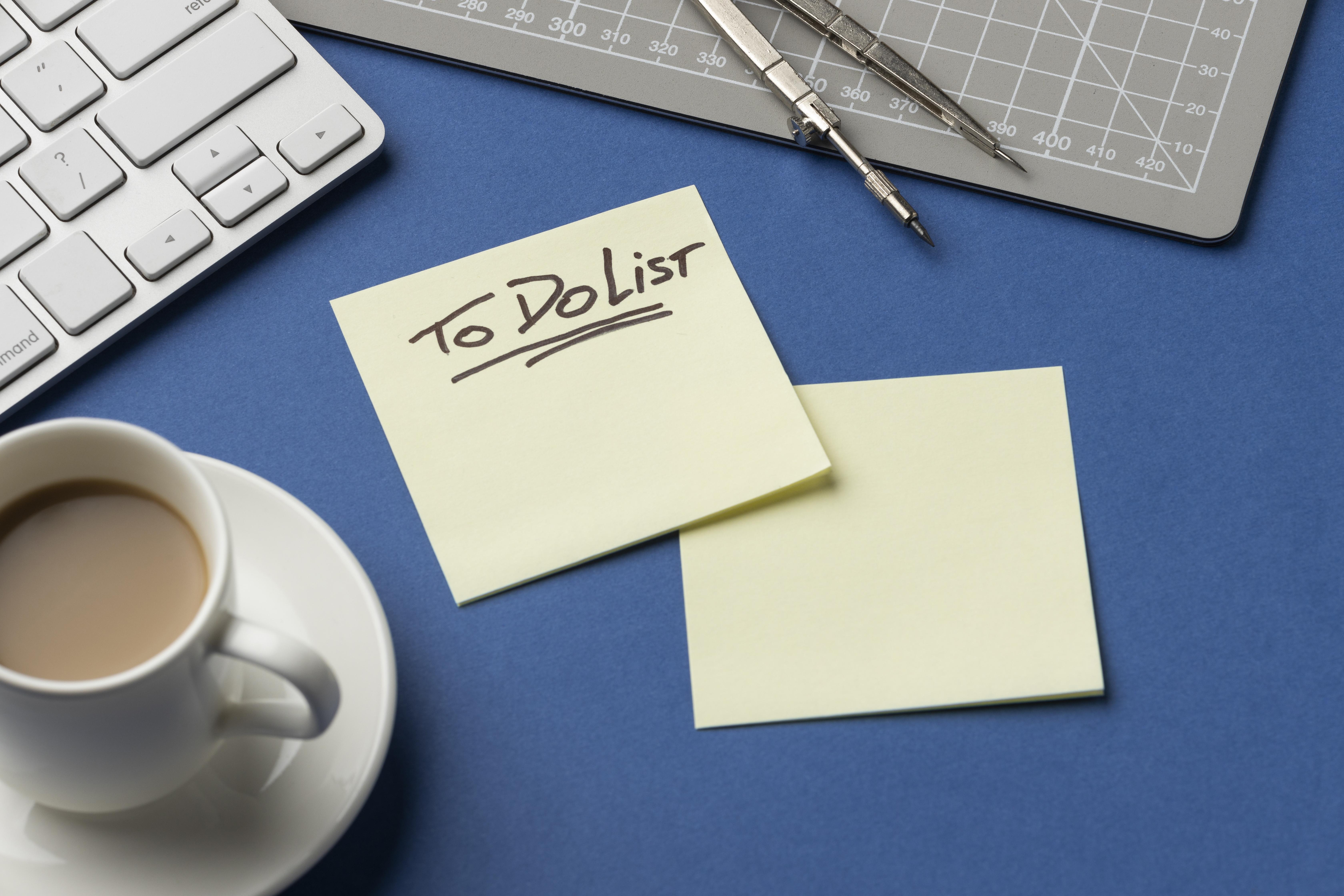 To-do list sticky note next to a cup of coffee
