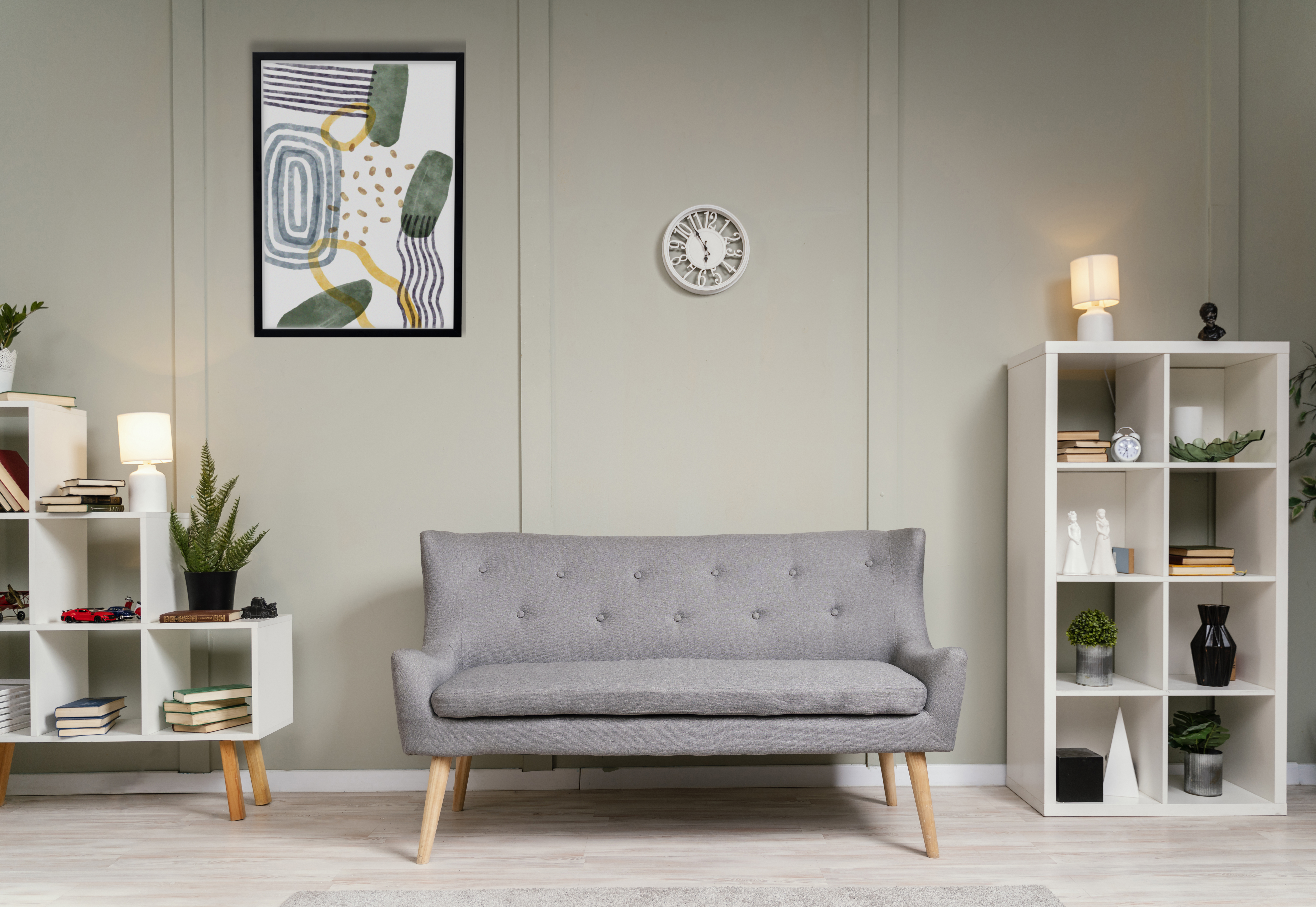 Neat living room with a grey sofa and shelves