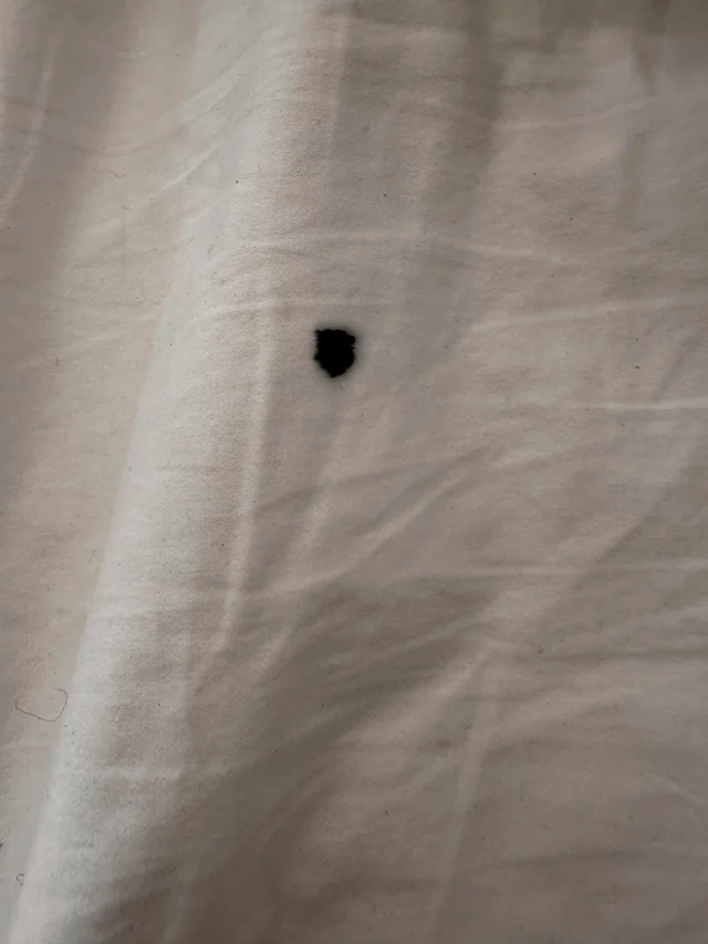 Ink mark on a white curtain