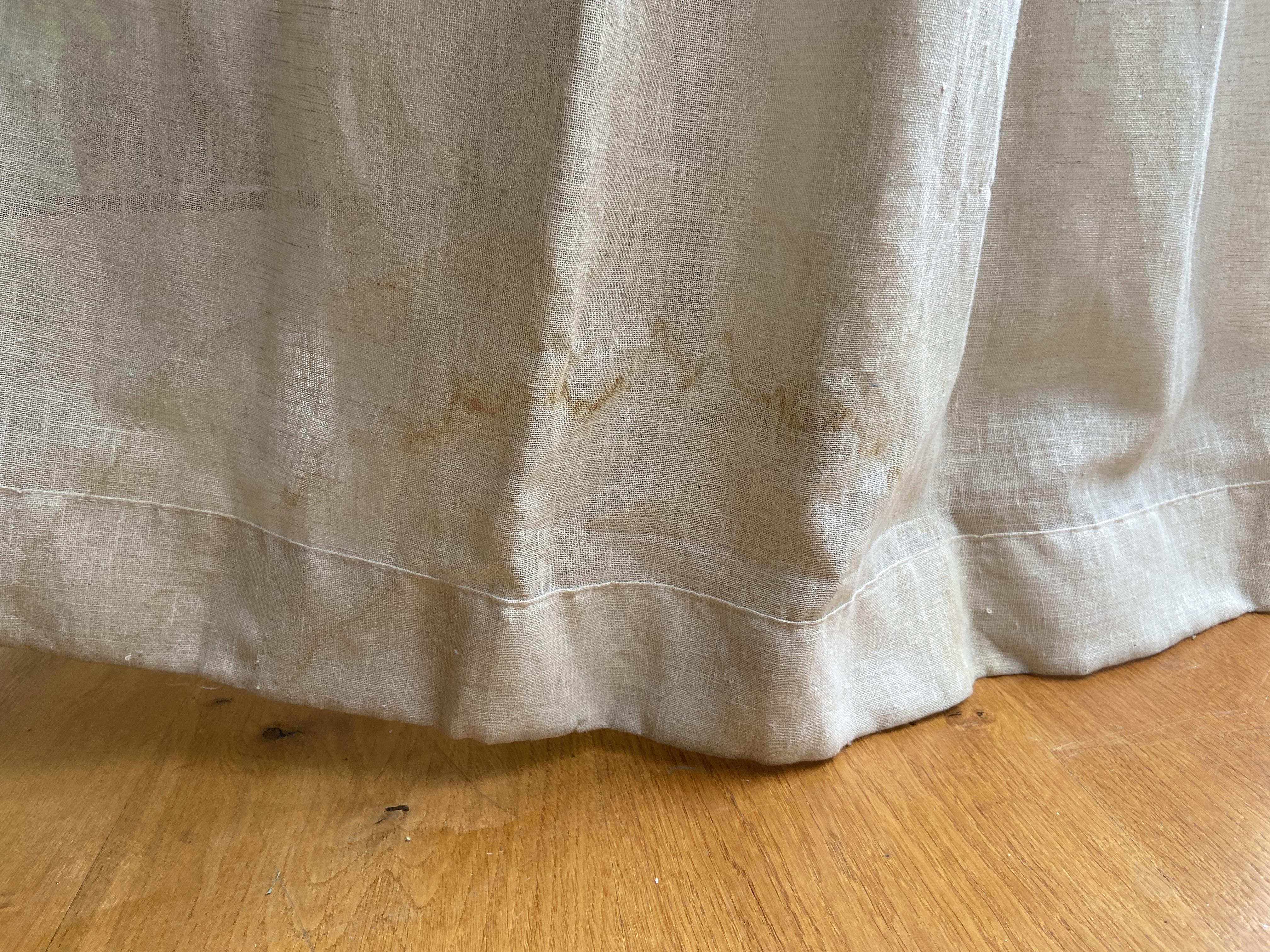 Curtain hem with brown watermark stains