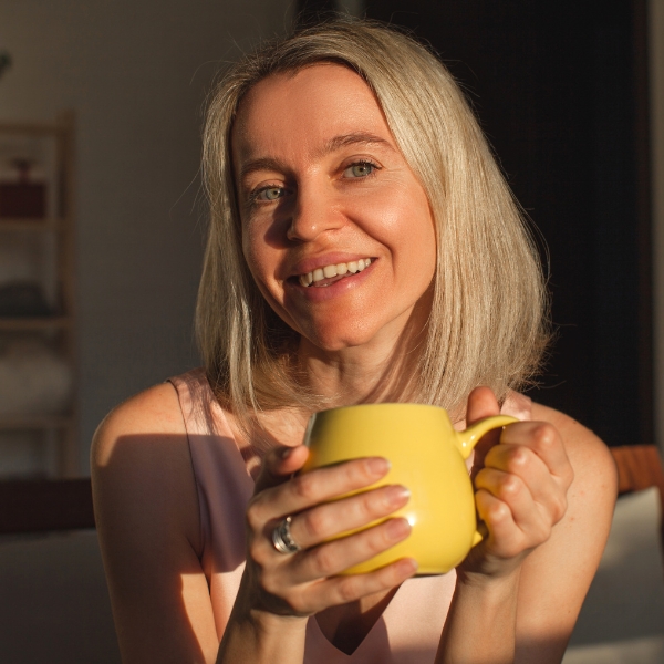 Smiling woman relaxing with a cup of coffee