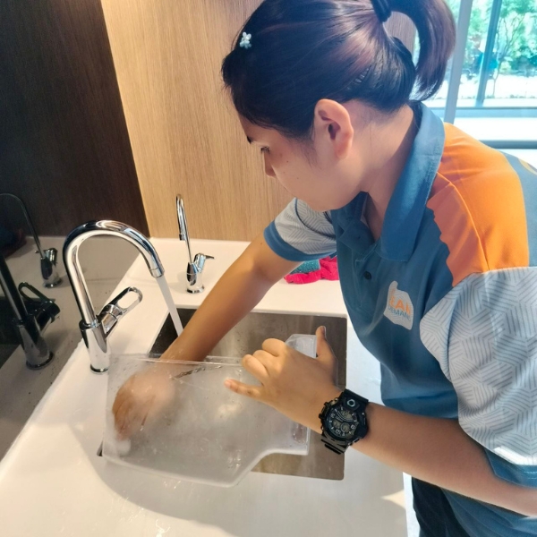 Clean On Demand cleaner washing a container at the sink