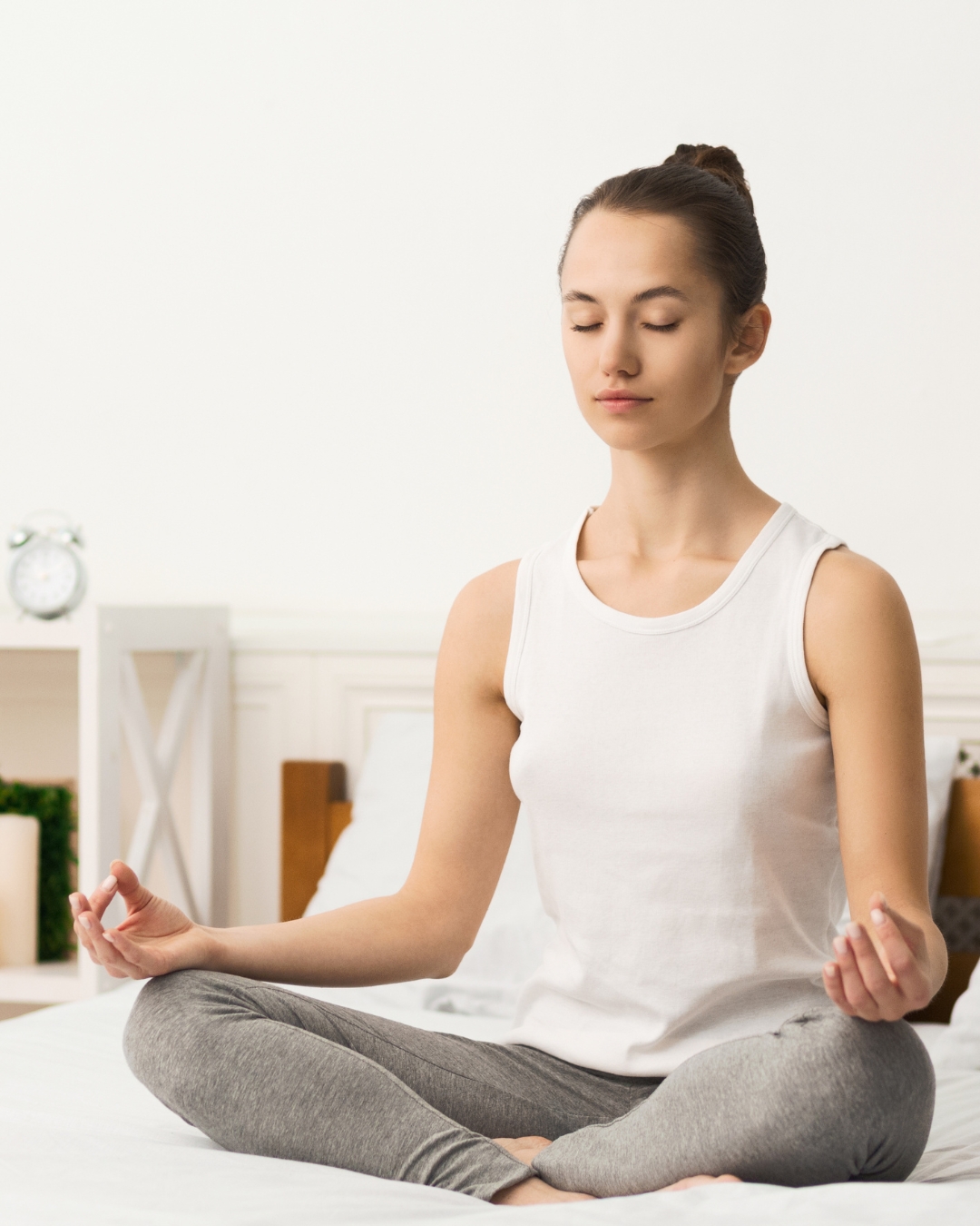 Woman meditating in a calm, clean room